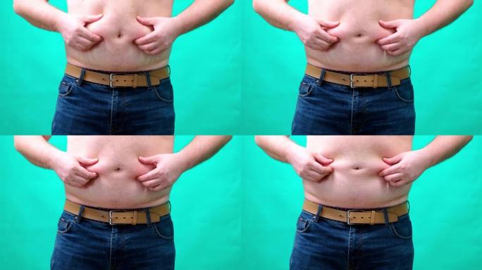 一个男人在grenn屏幕上显示出大胖的肚子。超重和暴饮暴食的问题。特写4K