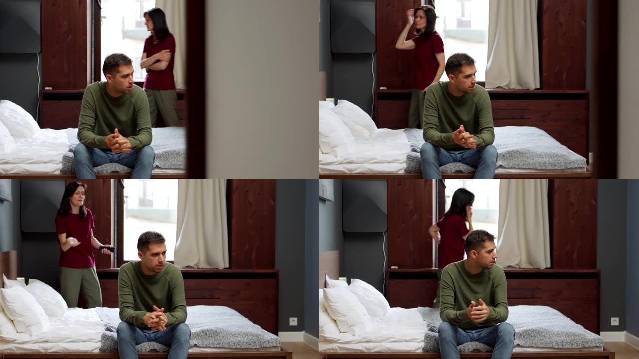 夫妻或母亲和成年儿子在卧室里吵架。焦虑的中年妇女用手机来回踱步，责怪坐在床上的沮丧的年轻人。两人都担