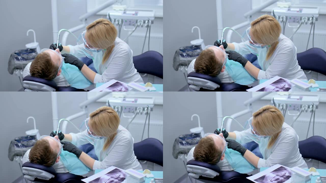 牙医戴着黑色无菌手套在患者的口腔中钻出一颗牙齿。牙科诊所用现代设备治疗龋齿。