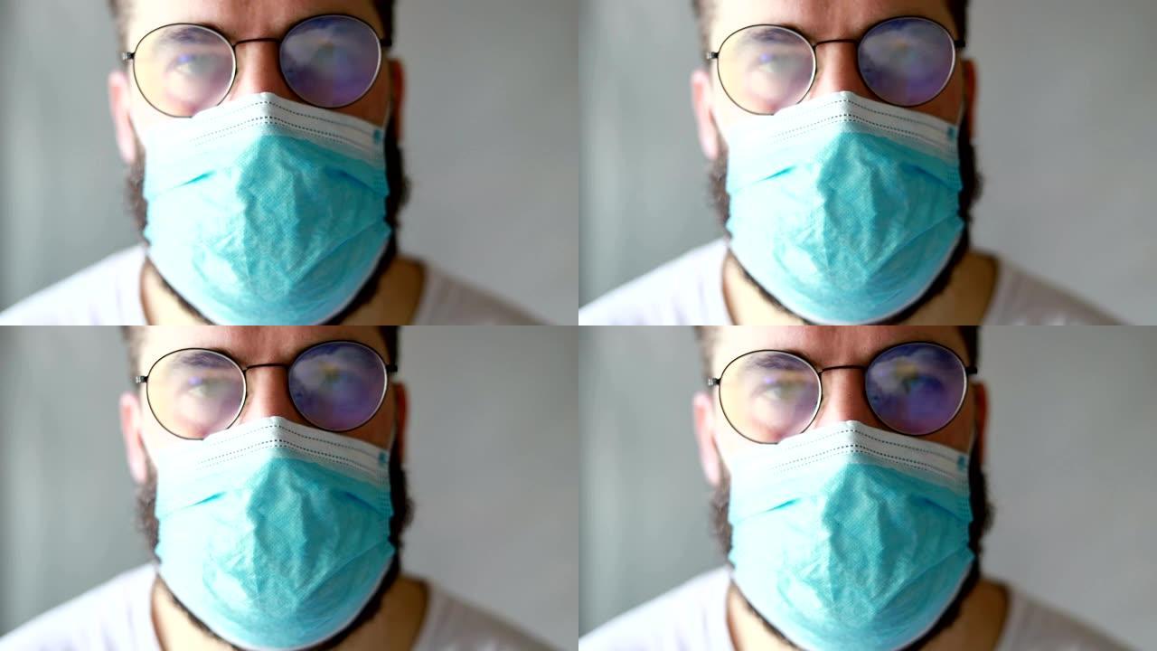 一个戴着防护面具的男人咳嗽。他生病了，感冒了，咳嗽了。