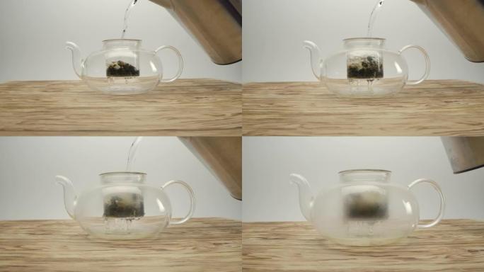 将水壶中的沸水倒入木桌上茶壶中的白茶中