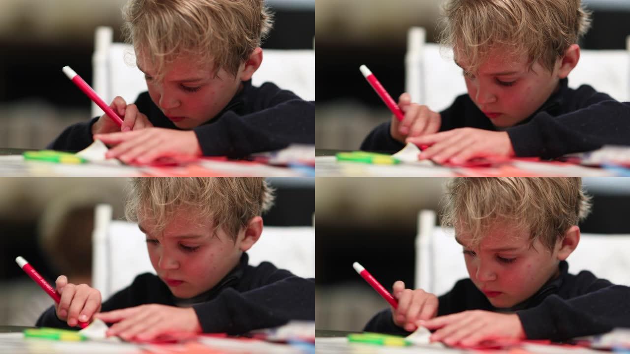 男孩在纸上用红笔画画