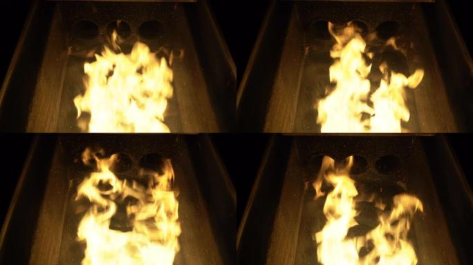 颗粒炉内部火焰的特写，用于加热房屋的生态和经济生物质。生物燃料概念
