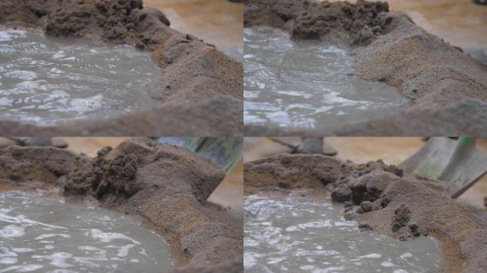 建筑工人将水泥与持水铲混合