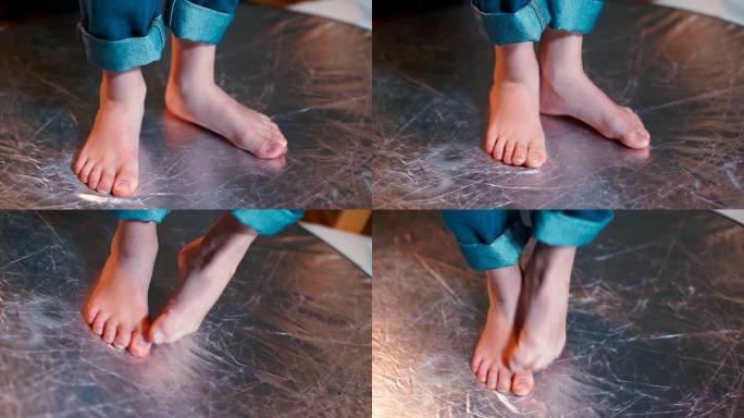 一个做脚部动作的男孩的脚的特写镜头。