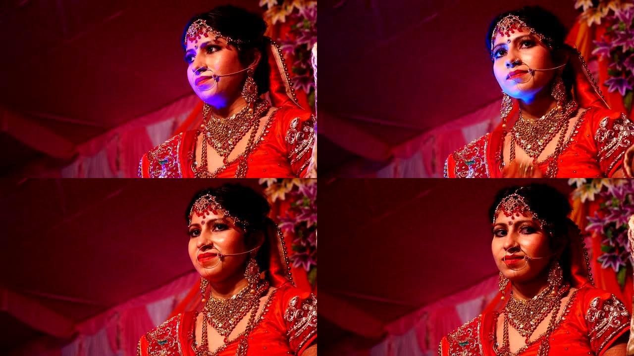 站在婚礼舞台上的美丽年轻印度新娘