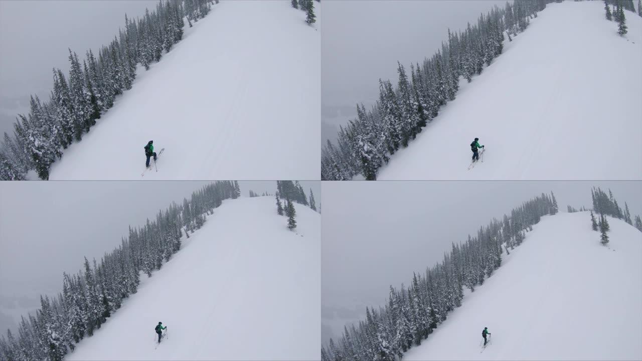 男子在冬季暴风雨中攀登陡峭的雪坡慢动作