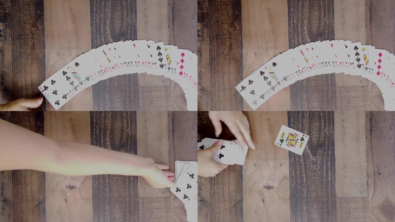特写，平躺，用标准牌展示纸牌技巧的女性手的镜头。
