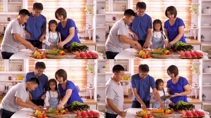 快乐的年轻亚洲家庭在厨房准备和烹饪健康的食物，家庭放松和在家里共度时光