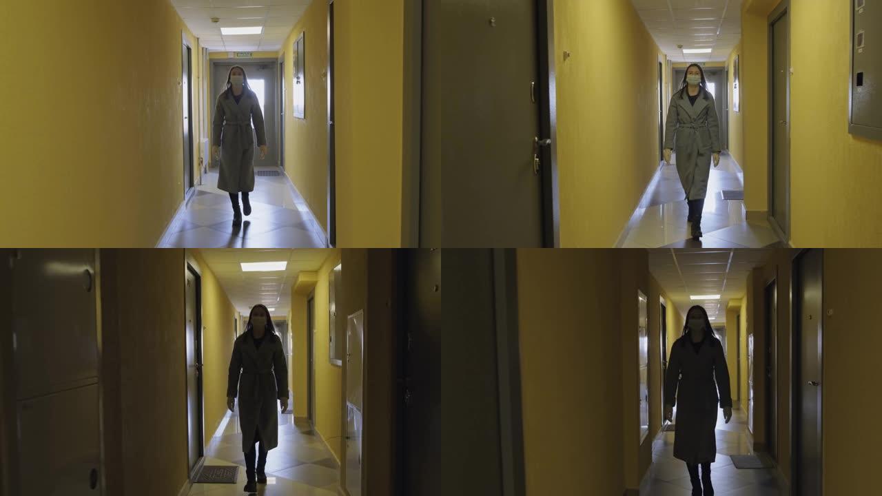 穿着灰色外套和医用口罩的可爱女孩沿着长长的走廊走。在大流行期间，保持良好的卫生习惯是很重要的。疾病预