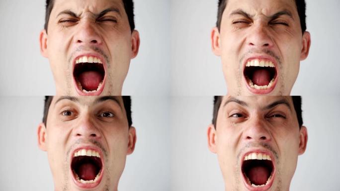 年轻的高加索愤怒的家伙的肖像直接对着镜头大喊。男人在白色背景上的情感。特写。