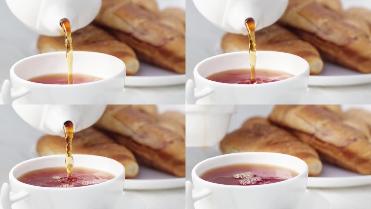 白瓷茶杯倒香草本饮料慢速特写。用4K红色相机拍摄