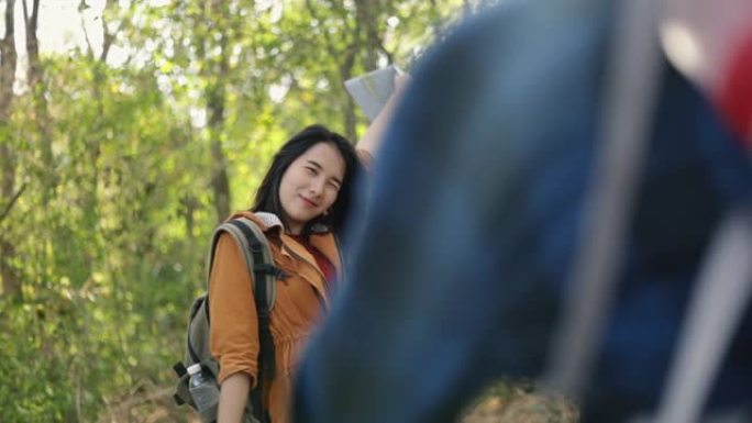 一个男朋友在一个阳光明媚的美丽夏天在森林里给女朋友拍照，享受假期的生活方式。