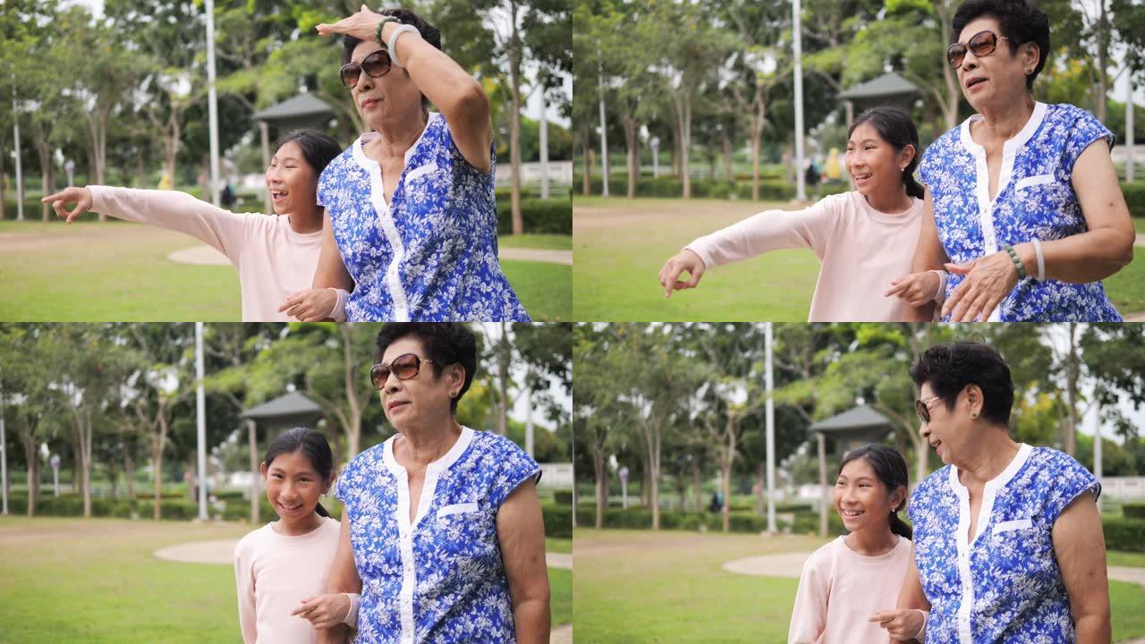 亚洲高级妇女在公园散步，她的孙子，生活方式的概念。