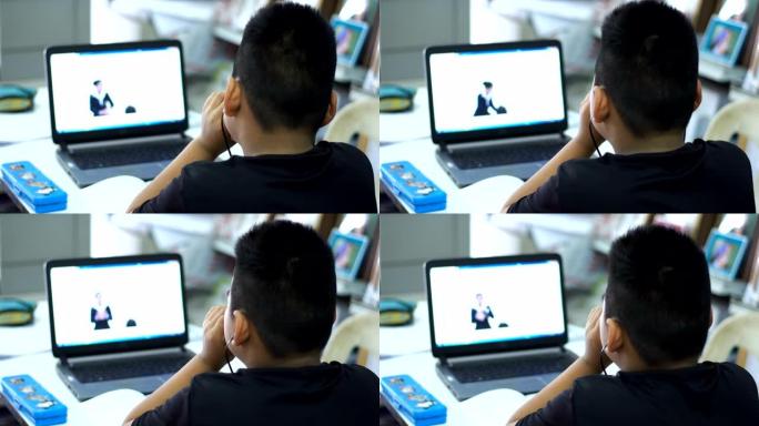一个亚洲男孩在家在线学习。在2020年全球新冠肺炎疫情的关键时刻