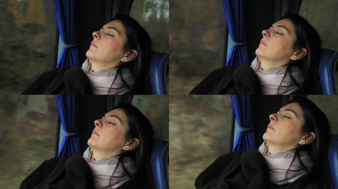坦率的现实生活中的女乘客在公路上旅行时在公共汽车上睡着了。睡在公共汽车窗户旁边的正宗女孩