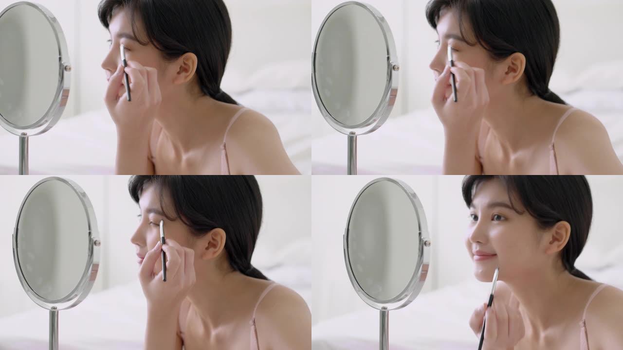美丽的年轻亚洲女性应用化妆眉毛刷，美容亚洲女孩使用化妆品化妆风格照镜子在家，时尚女性镊子自然，生活理