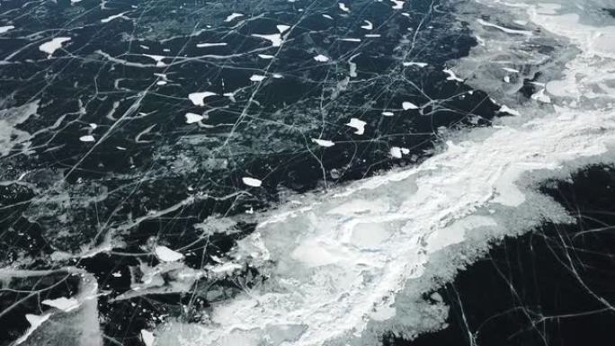 无人机在冬季贝加尔湖冰冻湖裂缝表面的美丽镜头。贝加尔湖是最大的淡水湖，也是世界上最深的