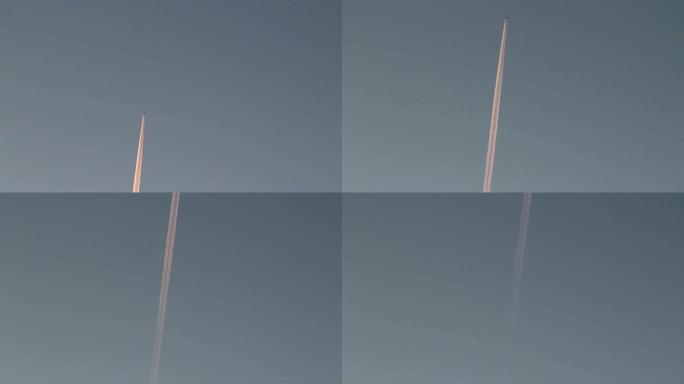 美丽的飞机步道在蓝天上日落红光，飞机层污染