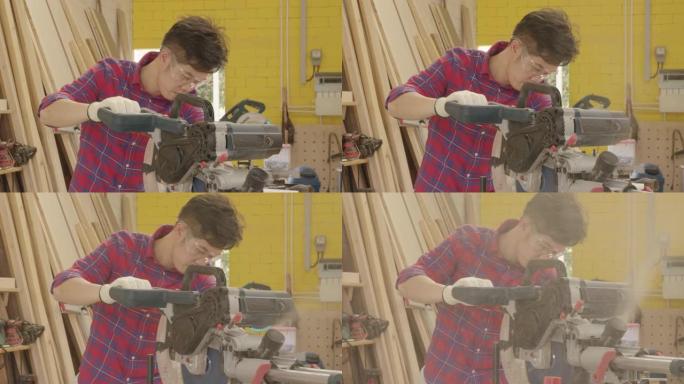 工人青年亚洲男子木匠建筑设计和切割木制锯床在车间办公工作室工作，个人经营理念。