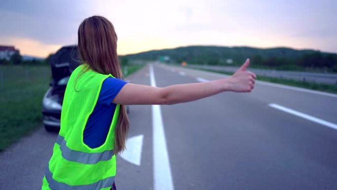 女人在高速公路上搭便车。