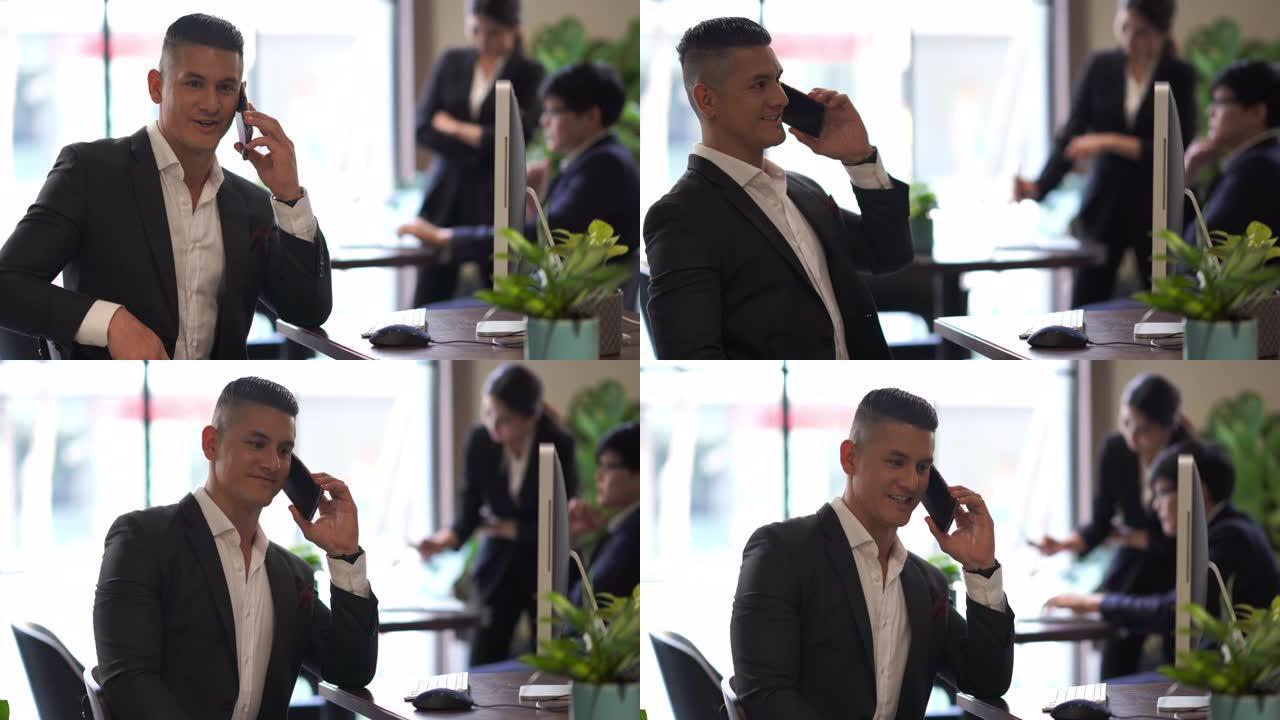 亚洲商人在办公室用手机聊天