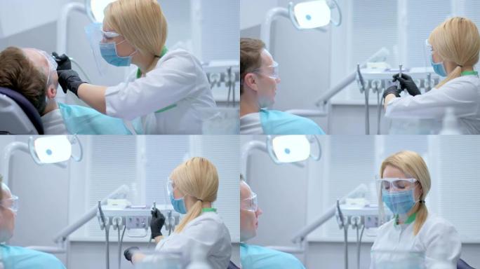 牙医完成了对患者的牙科治疗，将钻头放入单元中。医生已经钻完了一颗牙齿。满意的病人正在看医生。