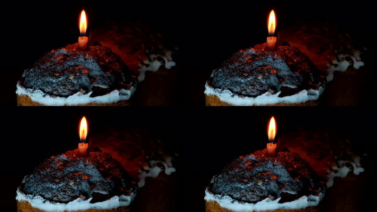 节日传统复活节蛋糕，黑色背景上有燃烧的蜡烛。复活节东正教甜面包。自制帕克斯假日概念