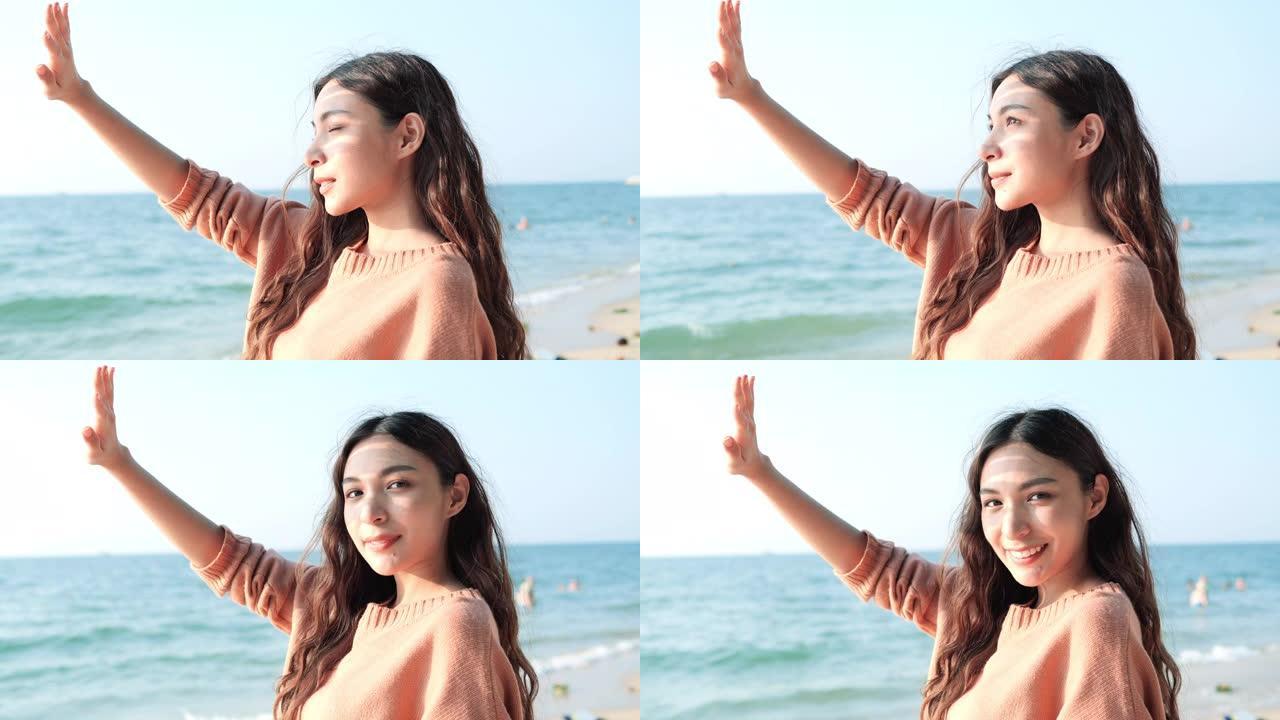 亚洲美丽的少女在海边海滩夏天快乐微笑。