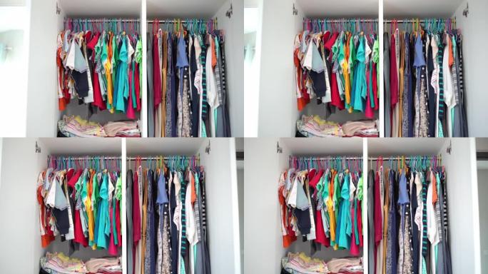 婴儿衣服和女人衣服挂在家里的衣柜里