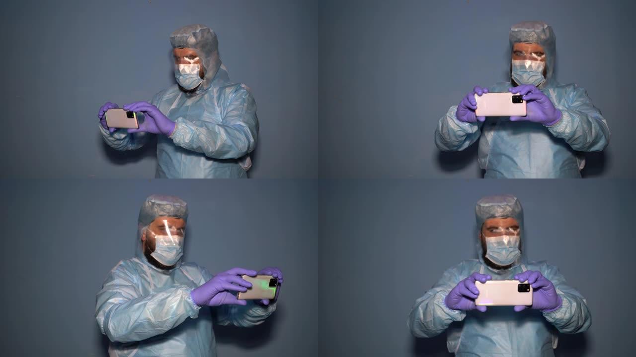 一位留着胡须的医生，穿着防护服，戴着雾蒙蒙的面具，手里拿着智能手机。新型冠状病毒肺炎大流行期间有分析