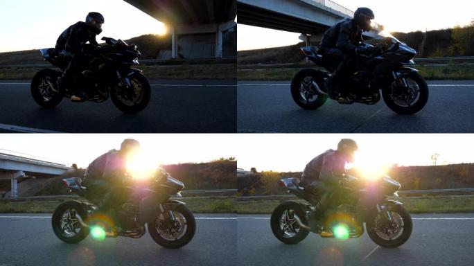 男子在高速公路上骑着现代运动摩托车，背景是太阳耀斑。摩托车手在乡间小路上骑摩托车。旅途中开车的人。自