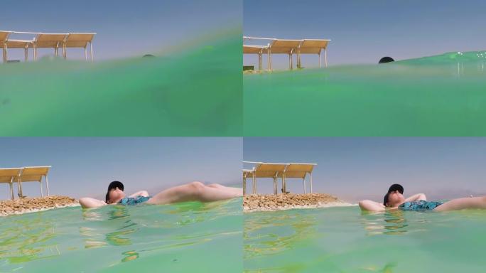 漂浮在以色列死海盐水中的女游客