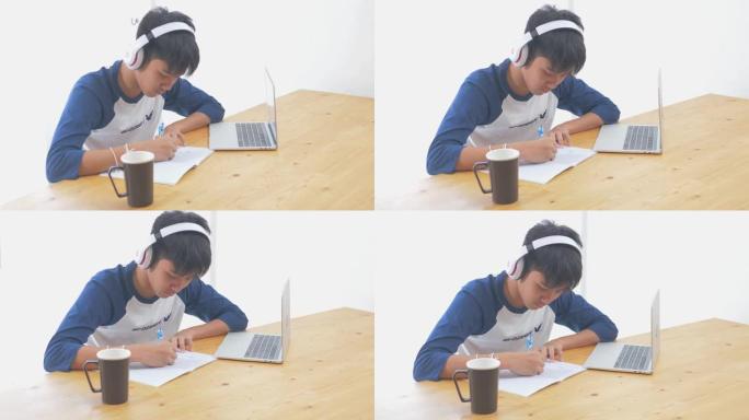 在科罗纳病毒期间，亚洲青少年使用笔记本电脑进行家庭教育概念。