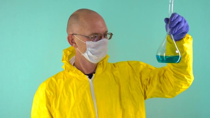 一位穿着黄色防护服，防护医用口罩和眼镜的化学科学家在蓝色背景下研究了烧瓶中的蓝色液体。化学概念