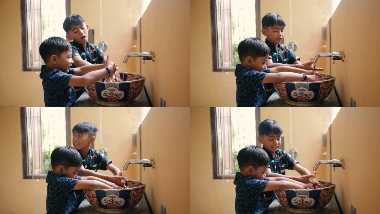 孩子们兄弟正在浴室洗手。印尼或马拉西亚兄弟姐妹一起洗手