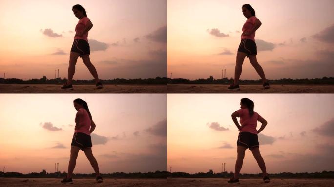 日落时慢跑的亚洲女性。