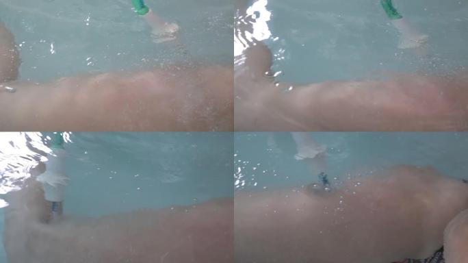 女性的脚特写镜头在装满水的浴缸里。水疗按摩大腿。