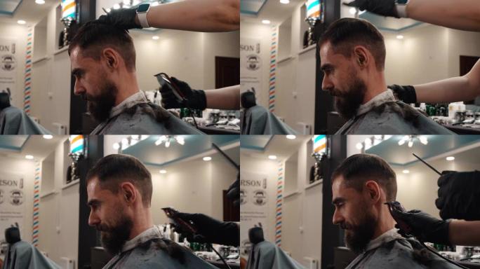 理发店里有胡子的男人用电机刮胡子。男性沙龙用电动剃刀剃刀剃毛男性颈部。理发店有修剪器的男性发型。