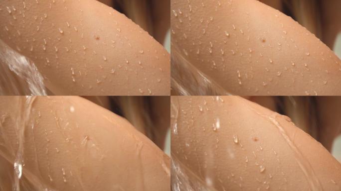 慢镜头里的女人正在洗澡。一个美丽的女孩正在洗澡和享受淋浴，她的手，背部和胸部的特写镜头滴在皮肤上。特
