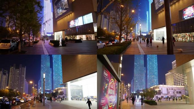 夜间青岛市市中心交通街著名购物中心侧步行延时全景4k中国