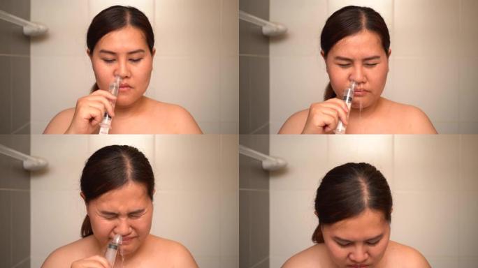 亚洲妇女用盐水洗鼻子