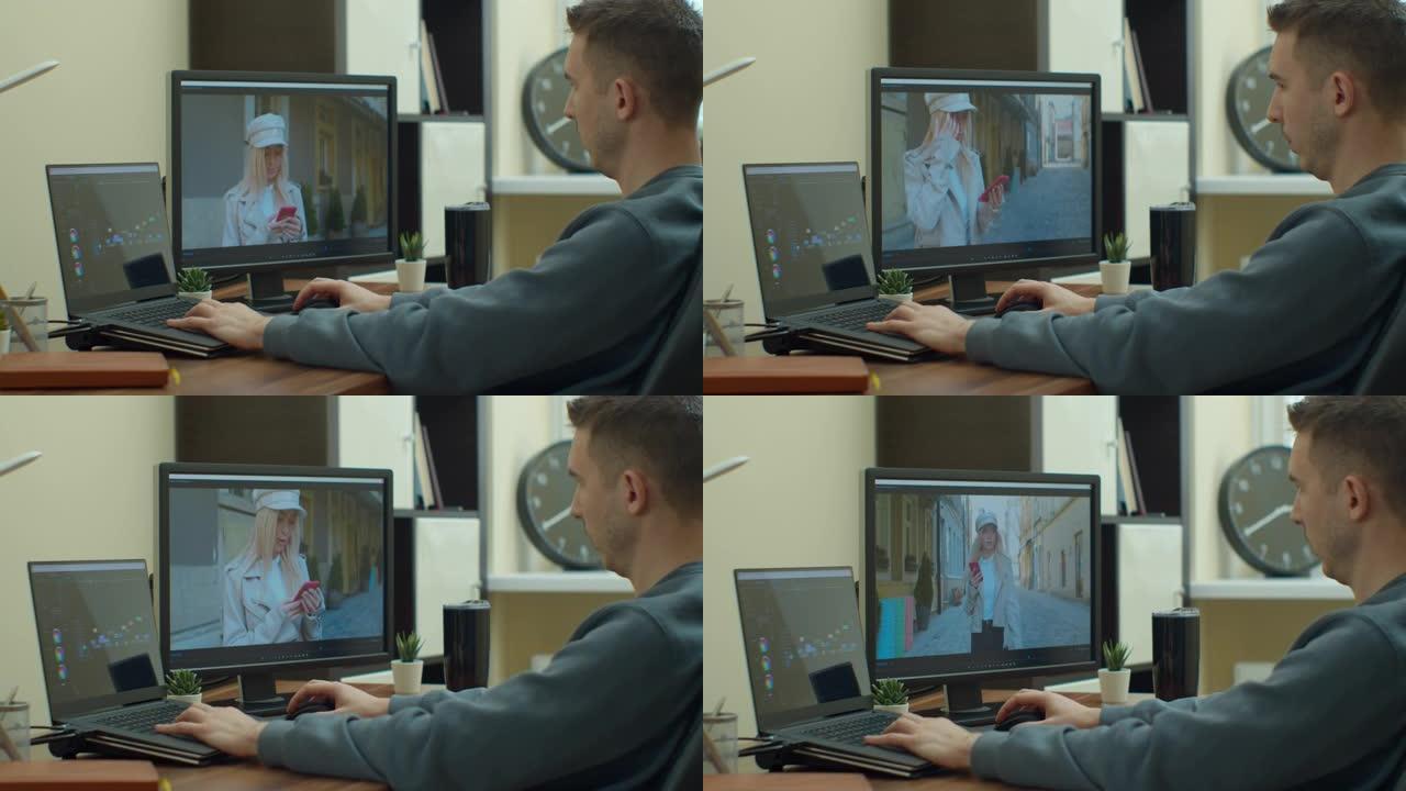 男子摄像师用两台显示器在他的个人电脑上编辑和剪切镜头和声音。