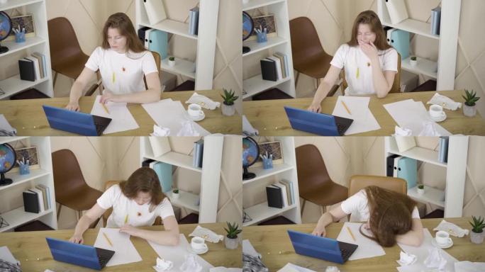 年轻女子在网上发送项目并低着头躺在桌子上的俯视图。疲惫的高加索自由职业者睡在电脑前。过度劳累，生活方