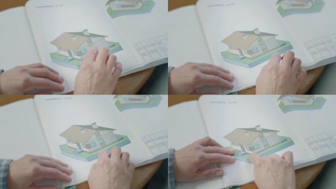 女人的手在图纸上展示房屋图纸。