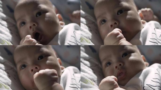一张可爱的亚洲新生男婴抬头的脸部照片