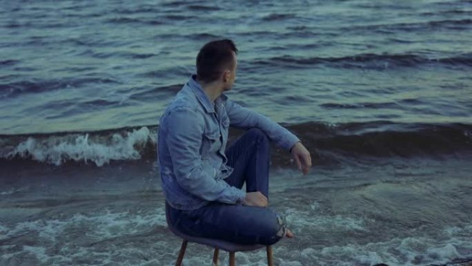 独自一人坐在海浪中的椅子上