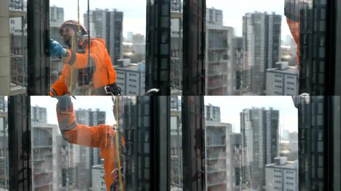 专业工业登山者通过玻璃清洗窗户，大都市建筑背景特写慢动作