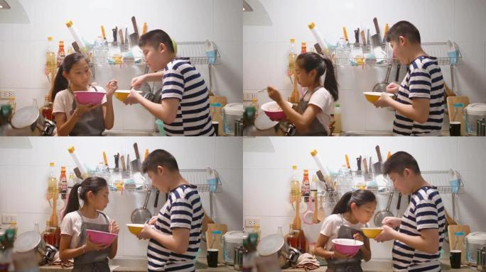 亚洲女孩和她的兄弟在家帮助自己烹饪煎蛋卷和食物。