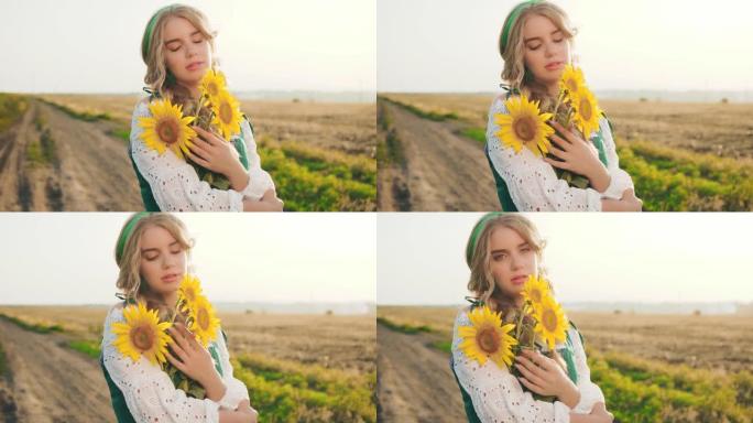 肖像年轻美丽的女人。花束黄色向日葵。巴伐利亚美女享受夏日大自然蓝天。模糊的背景农村道路麦田花。自然化